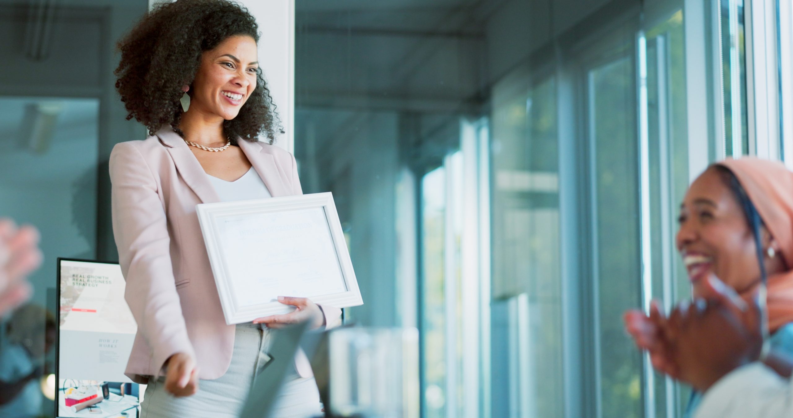 Women applauding each other in a business setting