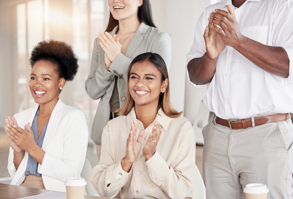 Group of diverse professionals applauding a win