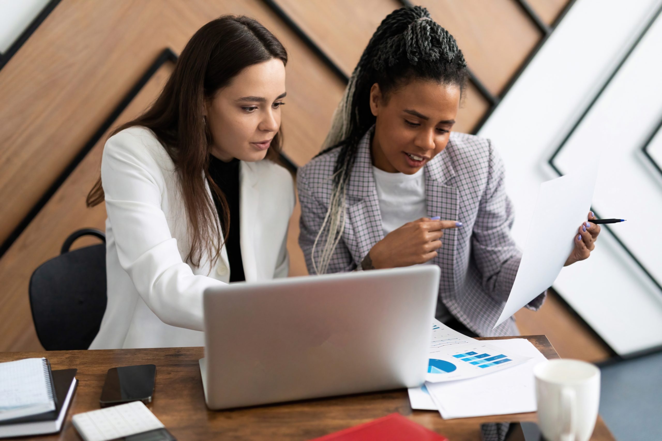 Female Colleagues Looking at a Findings on a Laptop