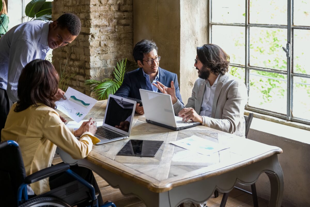 Diverse Group of Business People Reviewing Information Together at a Desk