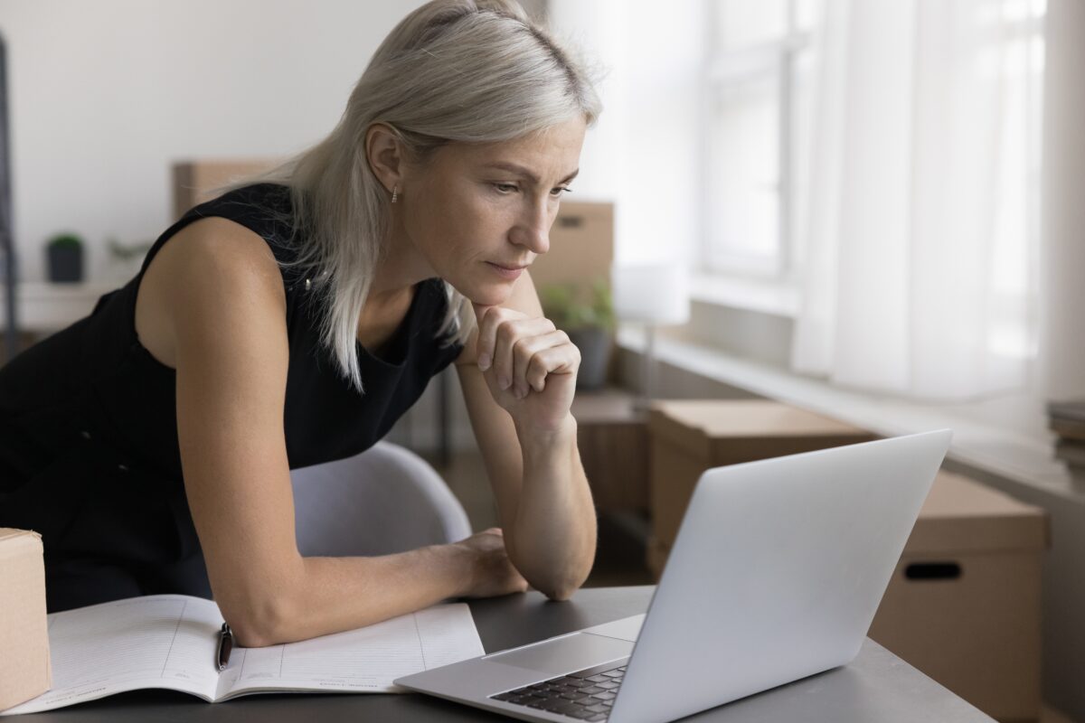 Business woman looking pensively at computer