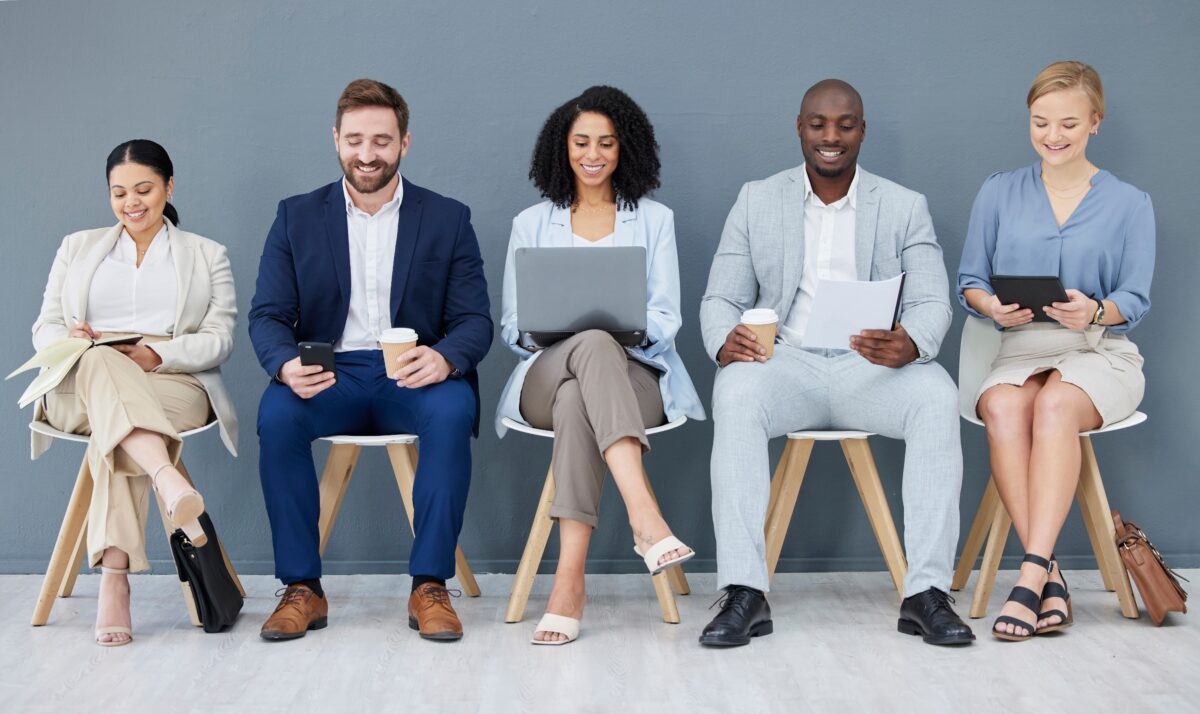 Diverse Group of Job Candidates Waiting in Seats for Interview