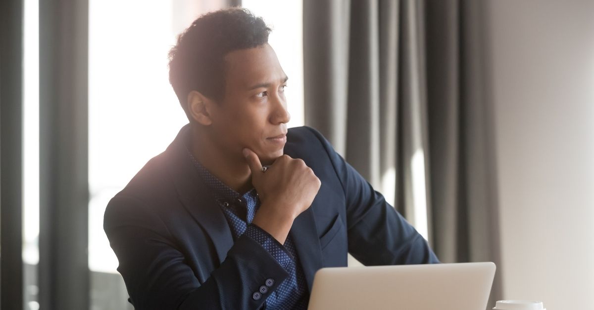 Man thinking in front of a computer