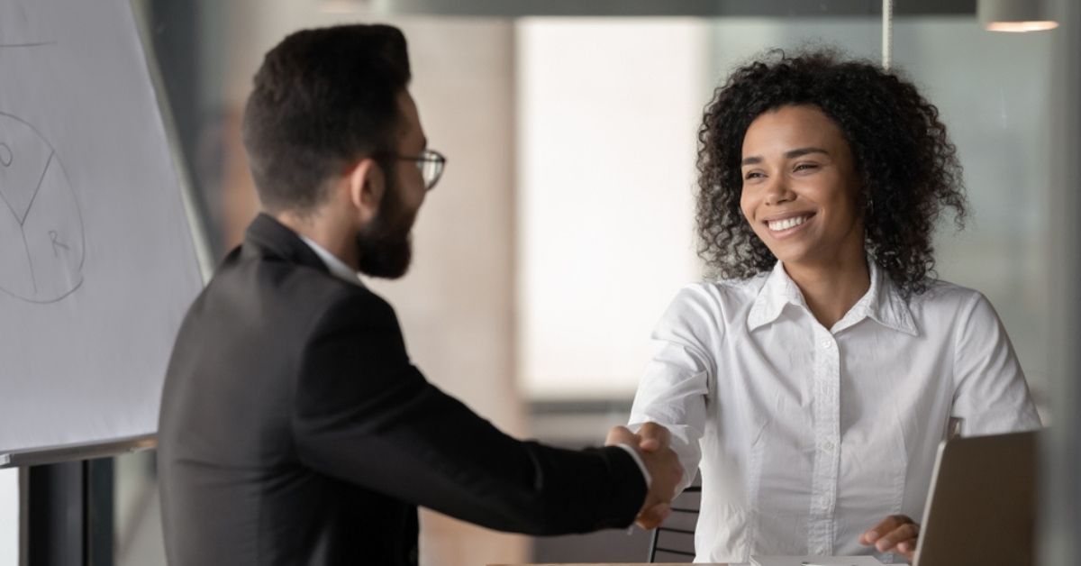 Woman and man shaking hands