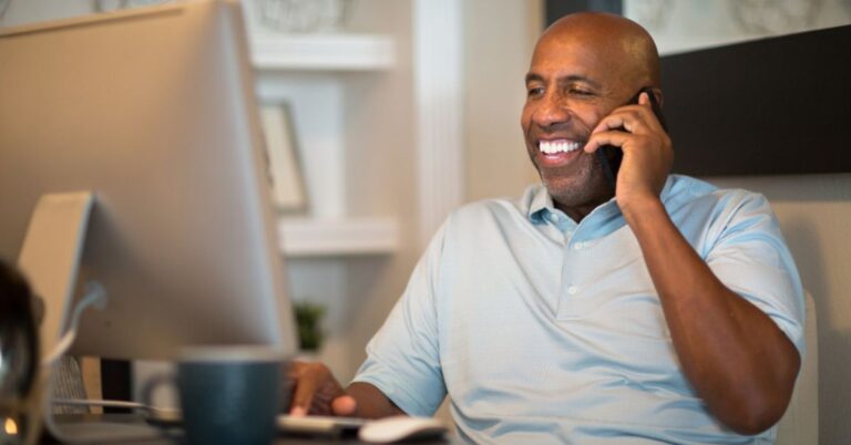 Smiling man talking on the phone