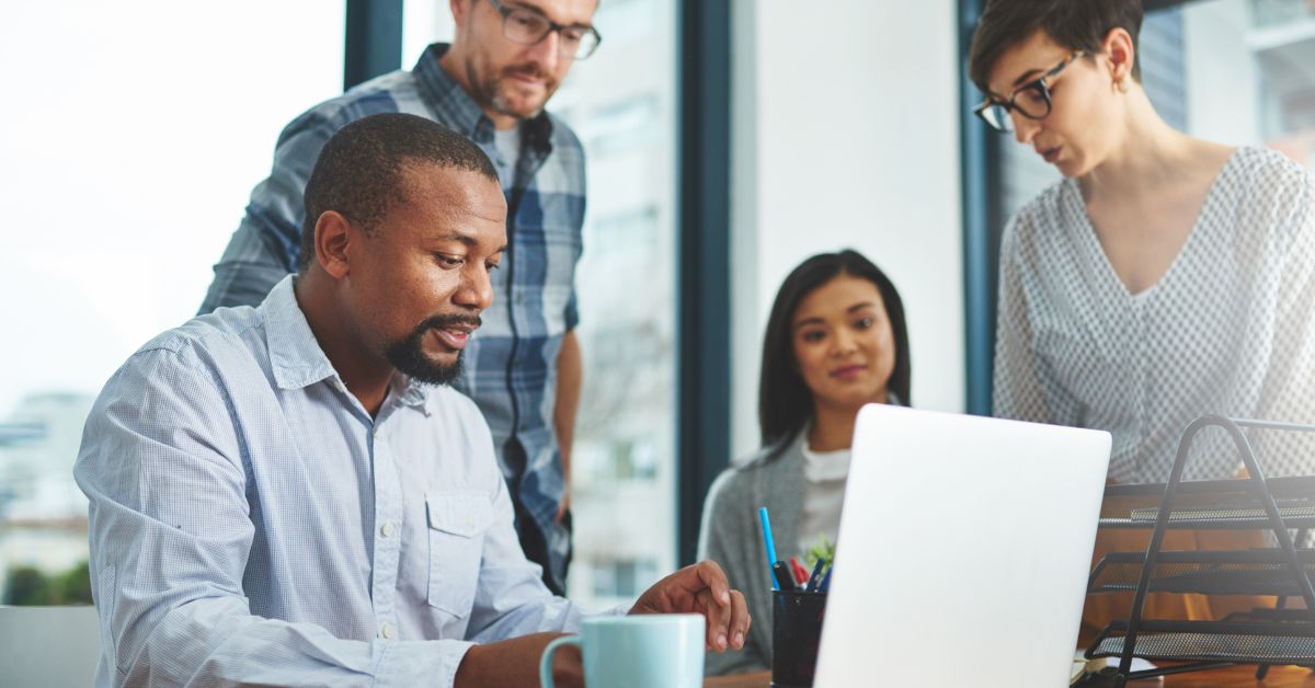 People at a conference table reading a report