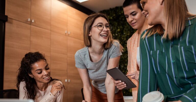 People smiling over a tablet