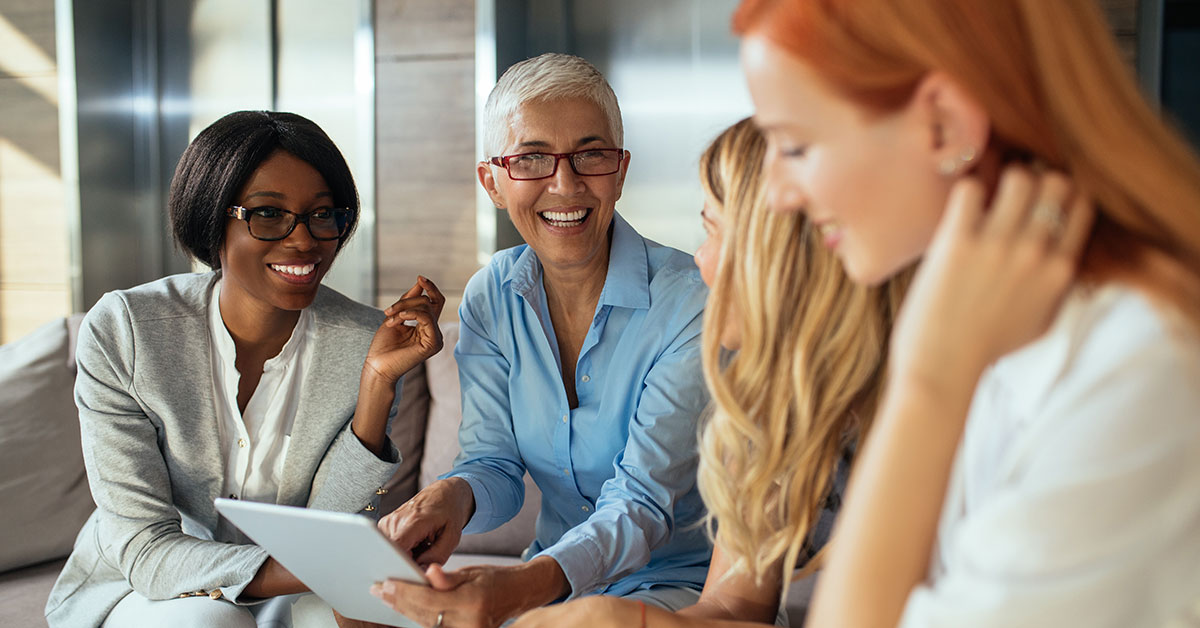 Group of professional women gathered around a table