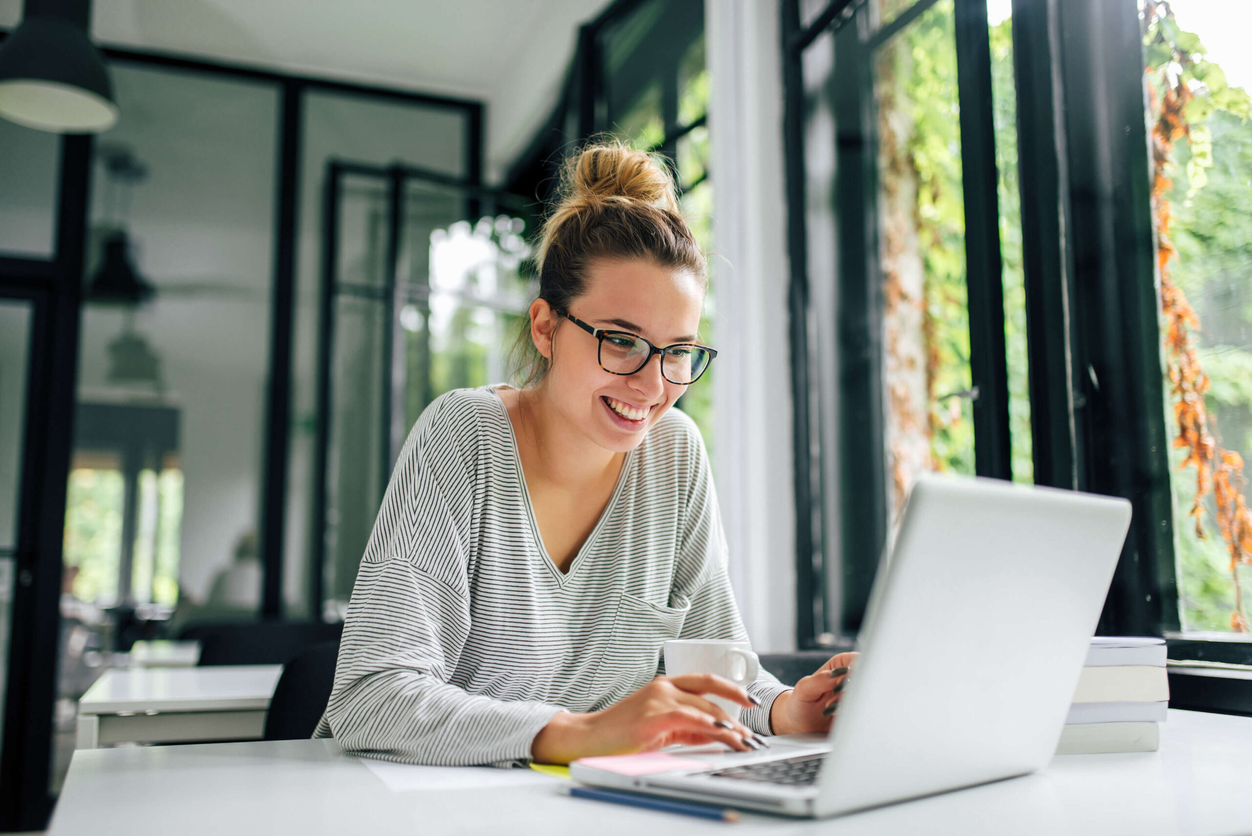 smiling professional works on laptop